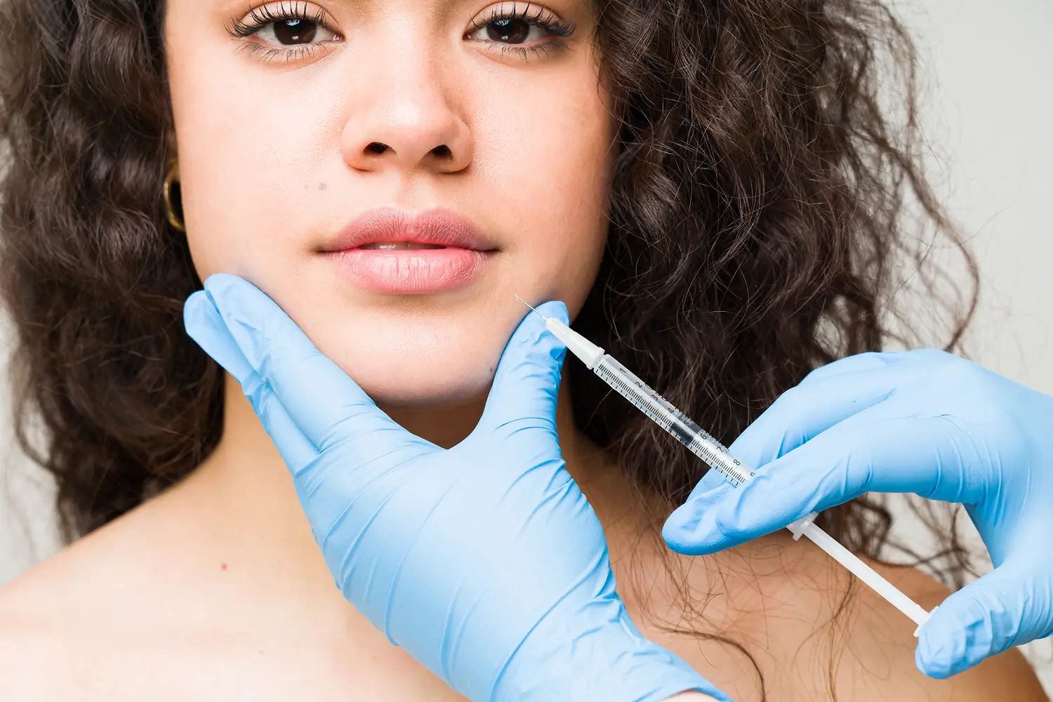 Injection procedure on woman's face