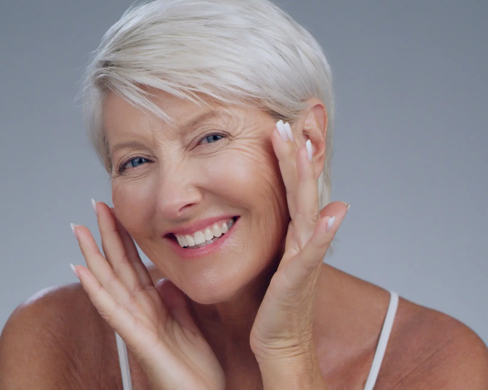 Smiling woman with short gray hair