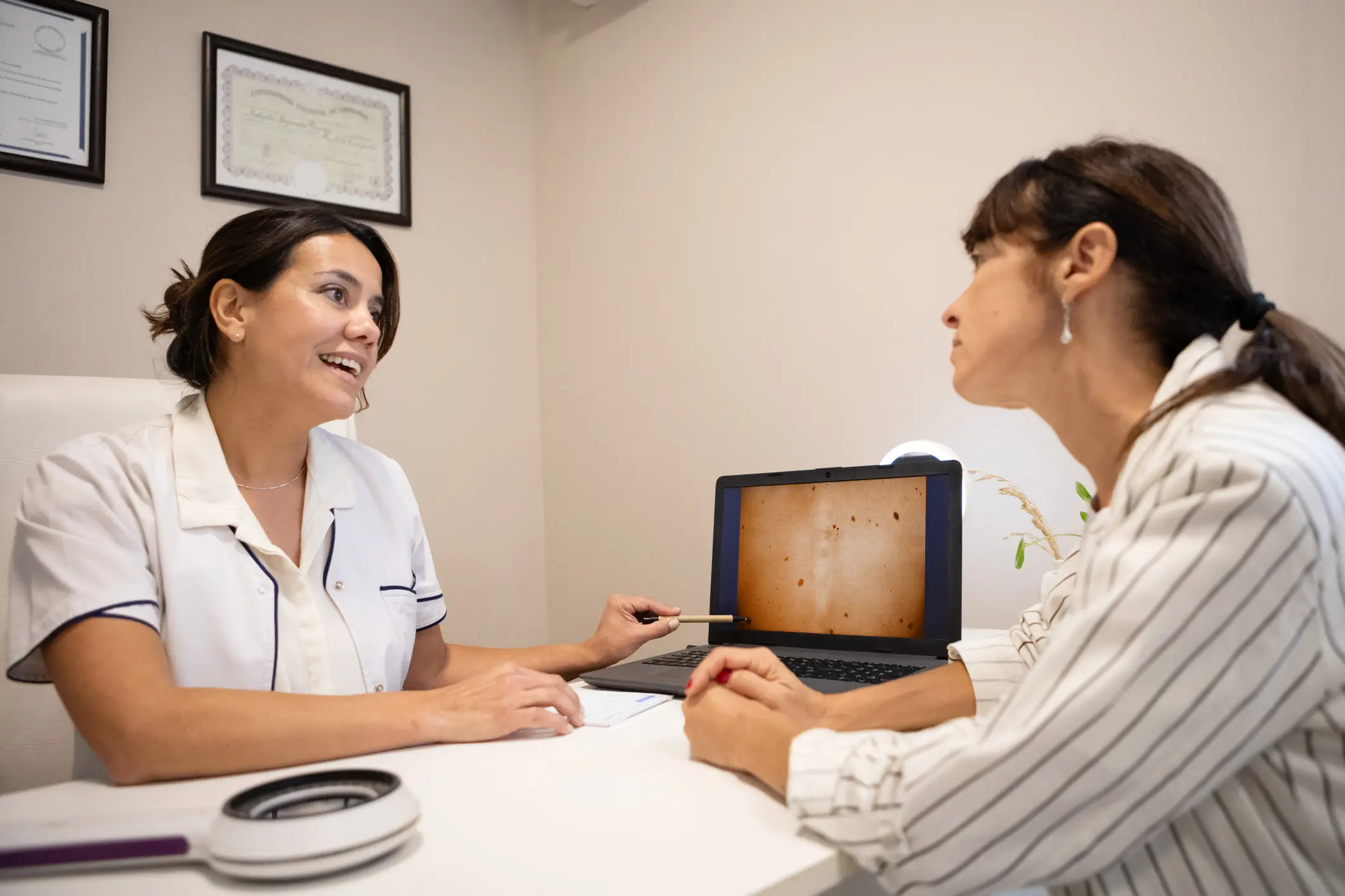 Doctor consulting patient with laptop images