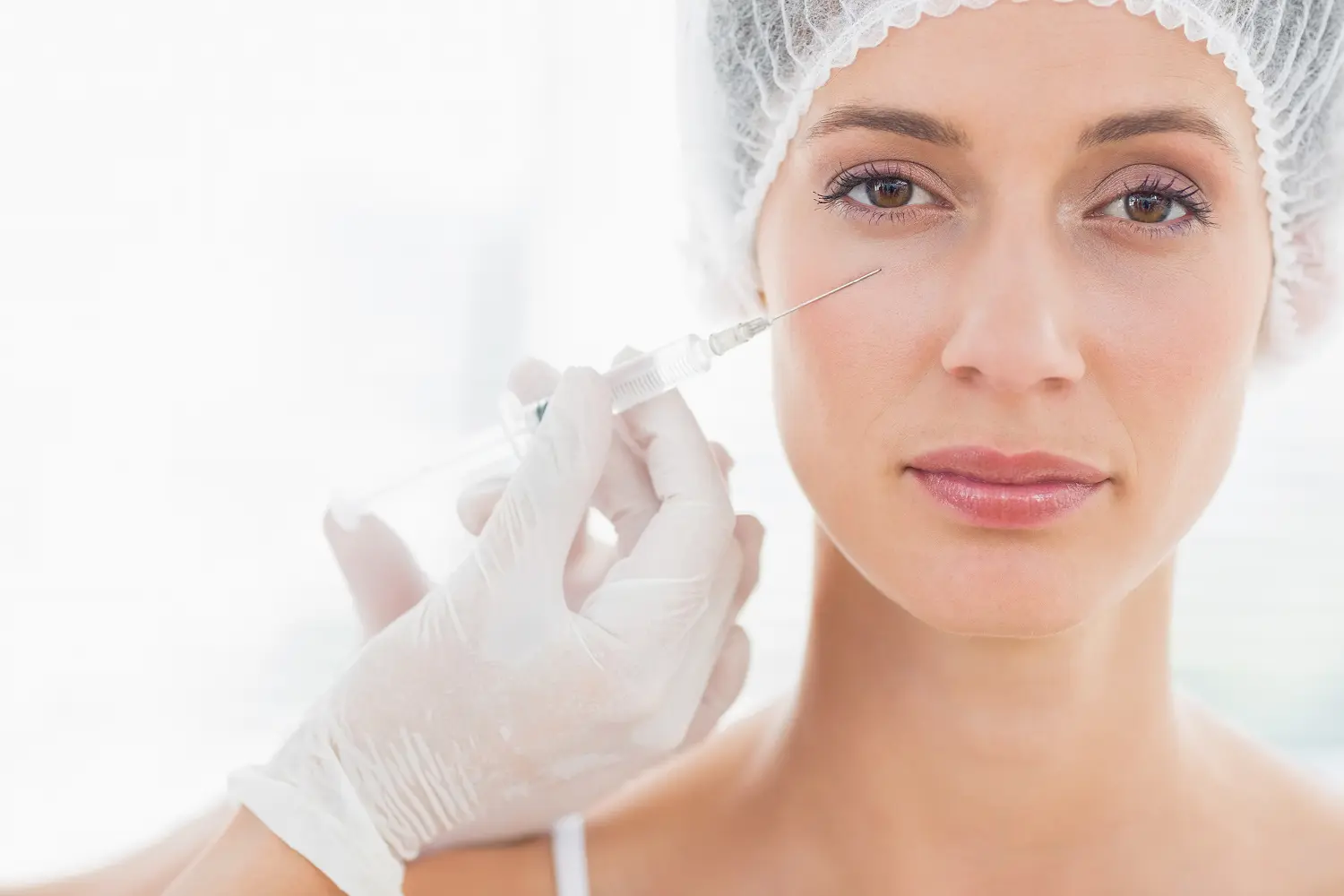 Nurse administering cosmetic injection to patient